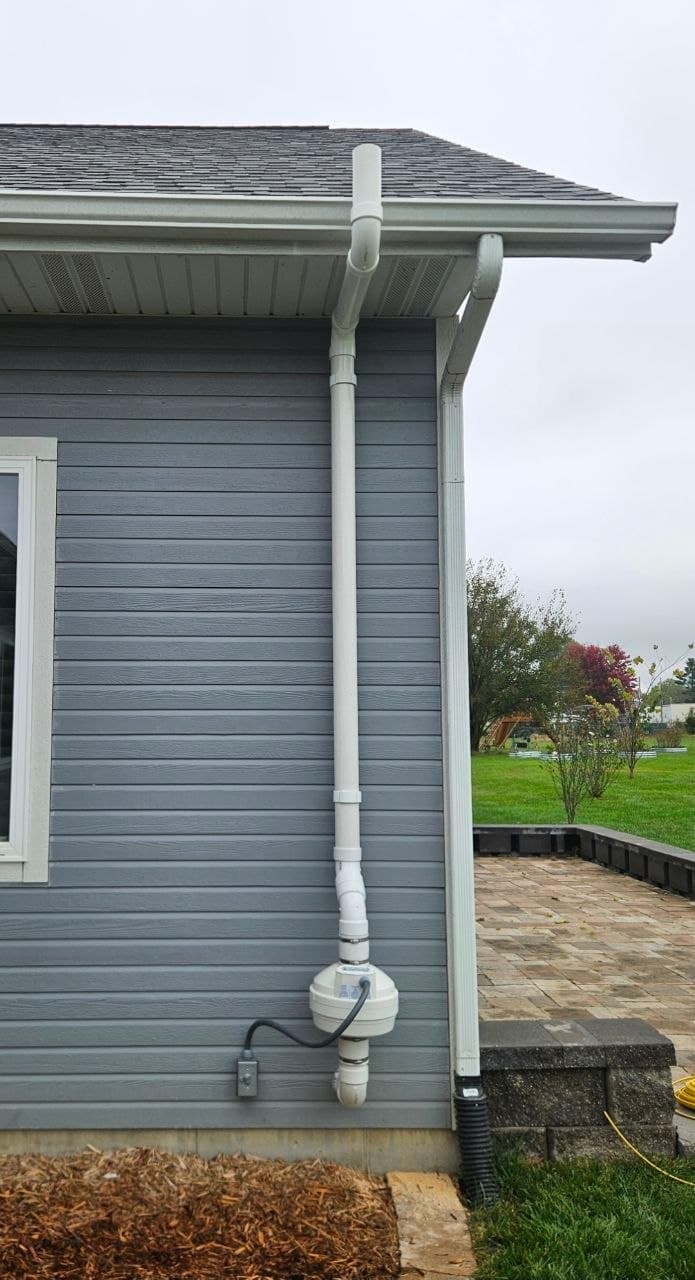 Radon vent pipe installation on exterior wall