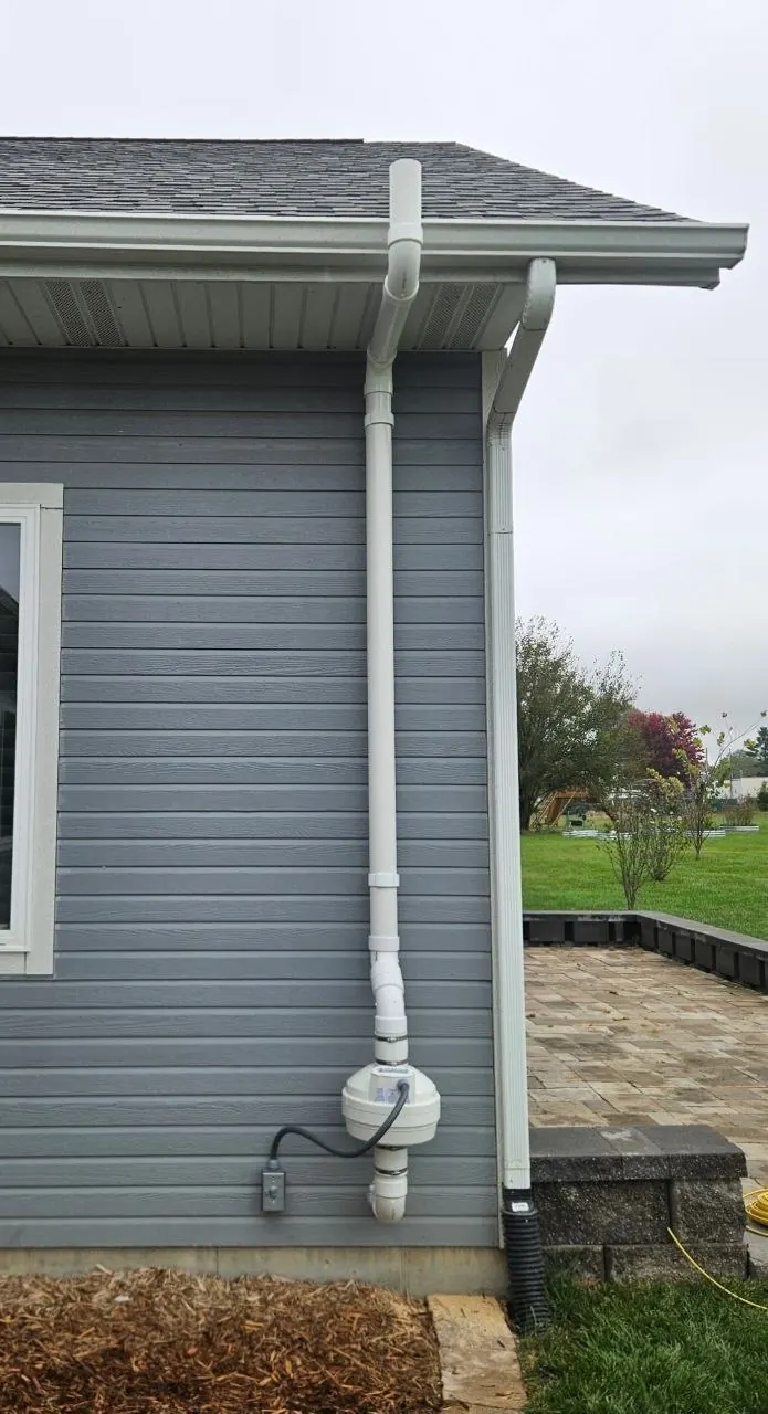 Radon vent pipe installation on exterior wall