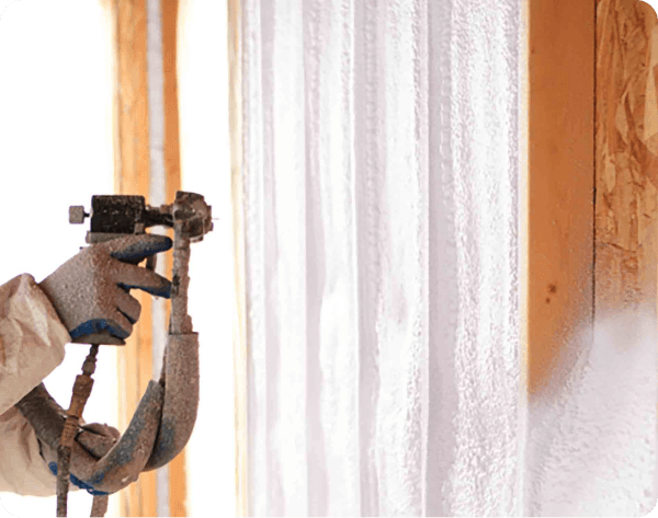 Spray foam insulation being applied to a wall